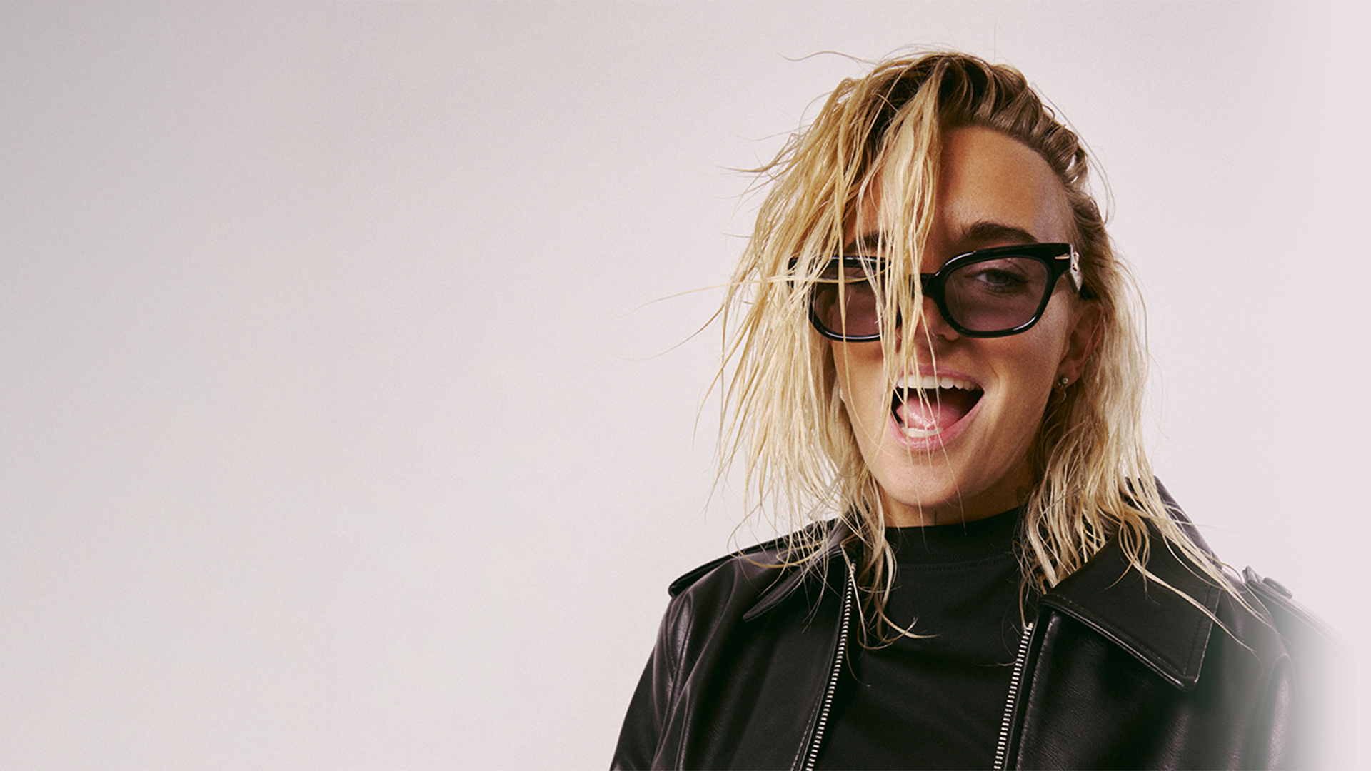 Singer G-Flip posing for the camera with sunglasses.