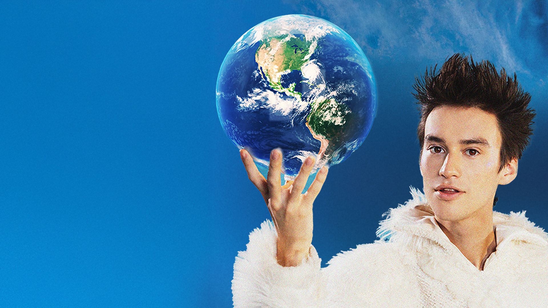 Artist Jacob Collier pictured with a world globe in hand against a blue background.