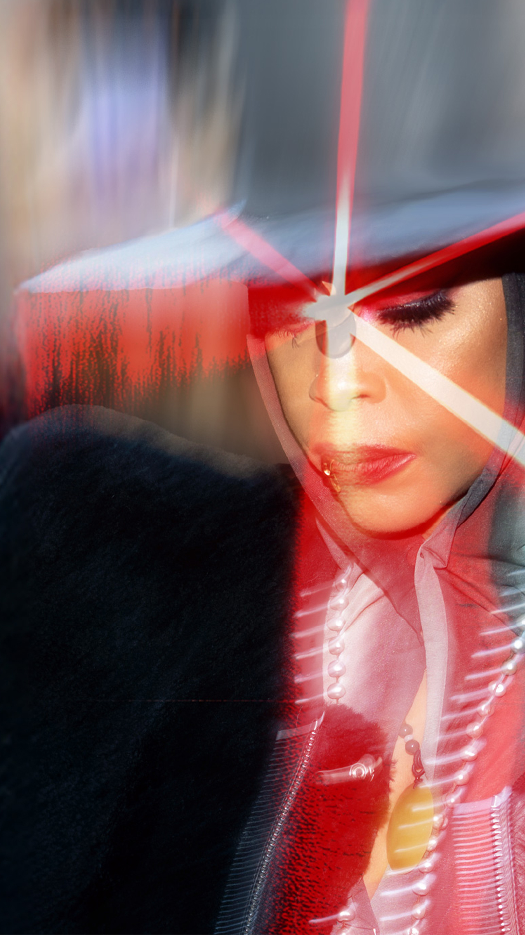 Singer Erykah Badu wearing a hat and posing with lasers.