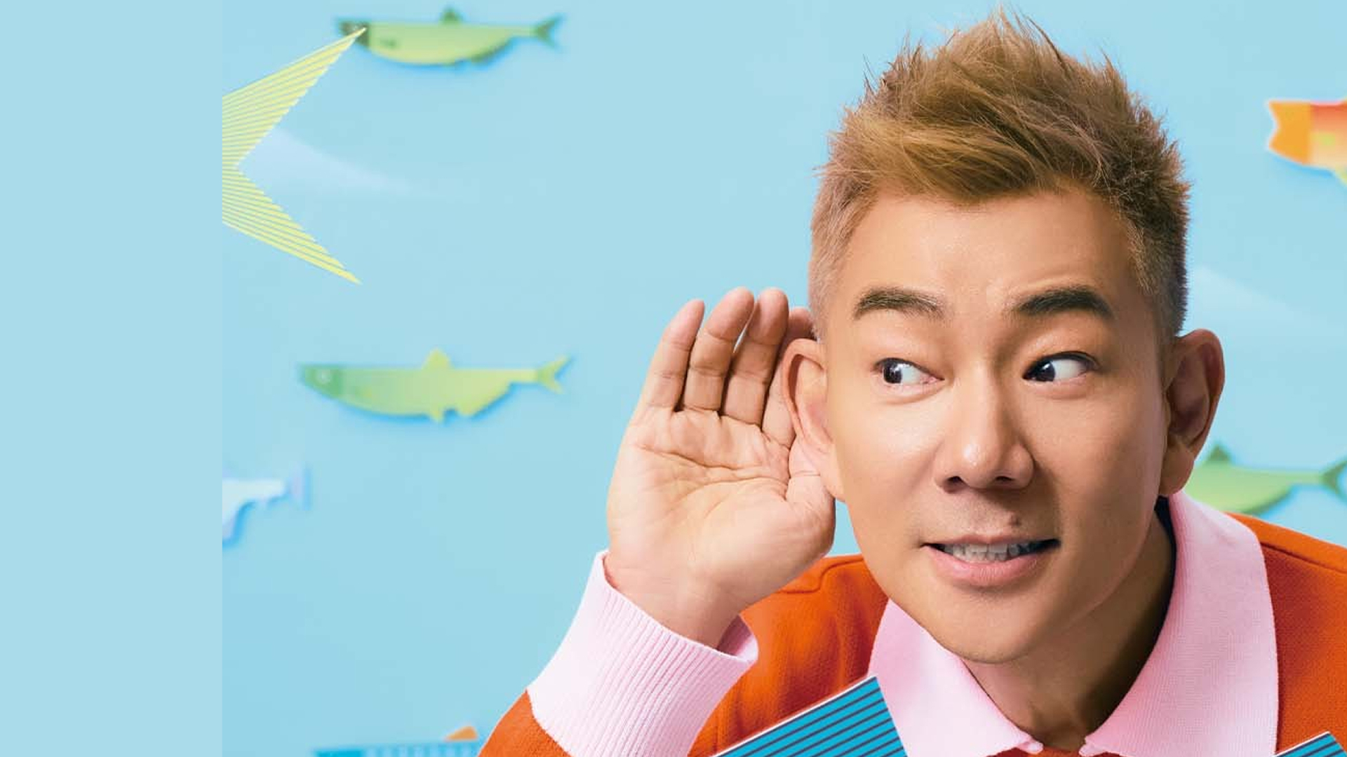Richie Jen jumps in the air surrounded by flying fish.